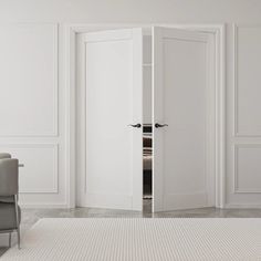 an open door in a white room with a chair