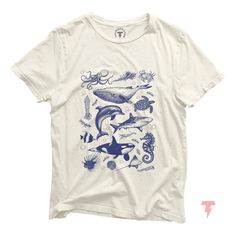 Dive into the timeless beauty of the ocean with our vintage sea life illustration t-shirt. Perfectly capturing the spirit of the sea, this shirt features intricate, classic artwork of various marine creatures that will transport you to a serene underwater world. Made from soft, high-quality cotton, this tee is designed for comfort and durability, making it ideal for everyday wear. Whether you're a beach lover, a marine enthusiast, or someone who appreciates vintage art, this shirt is a perfect a Aesthetic T Shirts Vintage, Ocean Clothes, Ocean Shirts, Sea Life Illustration, Ocean Clothing, Jellyfish Shirt, Dolphin Shirt, Ocean Wildlife, Sea Life Animals