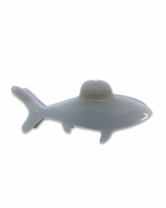 a white plastic toy that is shaped like a submarine or shark with an antenna attached to it