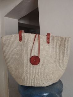 "White sisal tote bag with long shoulder length straps  DIMENSIONS Bottom width: 10\"/25.5cm Top width: 14\"/35.56cm Depth: 10\"/25.5cm Straps: 15\"/38cm SHIPPING All orders ship via DHL Express (3-5) days delivery time." White Straw Crochet Tote Bag, White Handwoven Straw Crochet Bag, Everyday Use Shoulder Bag With Rolled Handles, Natural Fiber Shoulder Bag With Rolled Handles For Everyday, White Natural Fiber Travel Bag, White Tote Bag In Natural Fiber, White Handwoven Straw Bag For Daily Use, Beige Basket Bucket Bag With Rolled Handles, White Bag With Braided Handles In Natural Fiber