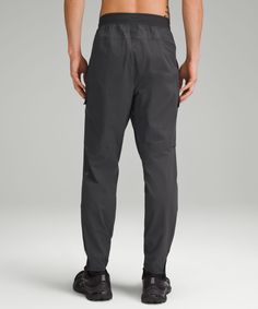 Anything But Routine. These Pants Combine Weather-Resistant Fabric With Built-In Ventilation So You Can Take Your Training Outdoors. Designed For Training. Classic Fit Tapers To Slim Below Knees:intended To Sit At Ankle For 32"-34" Inseam. Zippered Hand Pockets With Hidden Phone And Coin Sleeves. Secure Cargo Pockets. Zippered Side Pocket. Waistband Drawcord Can Be Worn Inside Or Out. Perforated Ventilation At The Back Yoke, Knees, And Fly. Zippers At The Cuff Make Them Easy To Get On And Off Qu Casual Straight Leg Lululemon Activewear, Casual Lululemon Straight Leg Activewear, Versatile Lululemon Bottoms With Elastic Waistband, Functional Lululemon Bottoms For Yoga, Functional Lululemon Bottoms With Elastic Waistband, Stretch Lululemon Pants With Pockets, Versatile Lululemon Activewear With Pockets, Lululemon Stretch Pants With Pockets, Lululemon Functional Workout Pants