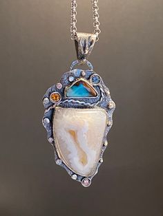 Agate Druzy with Australian Opal Gemstone Pendant in sterling silver   Materials: Silver 925, Agate Druzy, Australian Opal, Citrine, Blue Topaz, Pink Tourmaline    Height - 2 5/8" (full size with bail), Width - 1 1/4" Unique Handcrafted One-of a-kind Design Pendant Each Piece of Jewelry in my Collection is Absolutely One of a Kind! When you start wearing a piece of my jewelry you will fall in love with it more and more each day and feel that good Energy and Love that I pass into it while creatin Luxury Artisan Pendant Gemstones, Rough Gemstone Jewelry, Raw Stone Jewelry, Druzy Agate, Statement Pendant, Rough Gemstone, Metal Work, Unique Gemstones, Good Energy