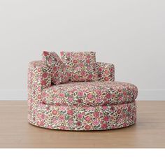 a floral print chair with pillows on it