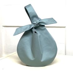 a blue vase with a bow tied around it