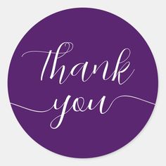 the word thank you written in white ink on a purple round sticker that says, thank