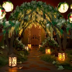 an archway decorated with lights and lanterns for a wedding ceremony in the evening or at night