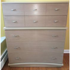 a white dresser sitting on top of a hard wood floor