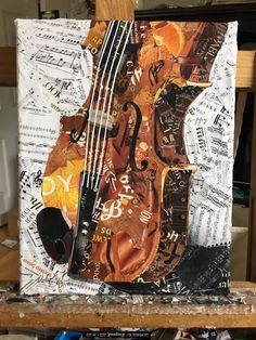 an art piece with musical instruments and music sheet collaged on top of it