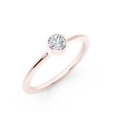 a rose gold ring with a white diamond