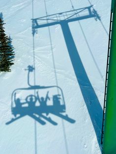 the shadow of a ski lift is shown on the snow