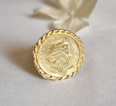 Gold coin ring, coin pinky ring, gold signet ring, coin signet ring, cocktail ring vintage style coin ring, vintage gold ring, pinky ring This gold coin ring is made of a British 5p coin which was decorated with braided gold filled wires and attached to a wide handmade band, creating a lovely signet ring. The coin coin ring is designed in a vintage style and is available both in 14k gold plating over brass or silver as well as sterling silver (see last photo). The ring is a great cocktail ring a Vintage Coin Signet Ring As Gift, Vintage Coin Shaped Signet Ring Gift, Vintage Coin Signet Ring For Gift, Elegant Engraved Coin Rings, Vintage Engraved Coin Signet Ring, Gold Coin-shaped Engraved Signet Ring, Gold Engraved Coin Signet Ring, Vintage 14k Gold Coin Ring, Gold Coin-shaped Signet Ring For Gift