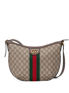 Crafted from beige canvas with brown leather trimming, this small Ophidia shoulder bag from Gucci is detailed with the brand's signature green and red Web stripe and a gold-tone metal Double G logo plaque. You'll never want to carry everything in your pockets again. Featuring all-over GG Supreme pattern, antique effect gold-tone hardware, a leather trim, an adjustable leather strap, a top zip fastening, a main internal compartment and an internal zipped pocket. | Gucci small Ophidia GG shoulder Ophidia Gg Small Shoulder Bag, Gucci Ophidia Bag, Street Style Bags, Gucci Ophidia, Roshe Run, Buy Gucci, Gucci Models, Bags Aesthetic, Nike Lebron