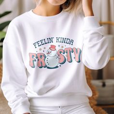 Chase the winter blues away and bring some festive fun to your wardrobe with the Feelin' Kinda Frosty Funny Snowman Winter Sweatshirt. This whimsical graphic sweatshirt features a smiling snowman and playful text that will put a smile on your face all season long. Show off your playful spirit and get in the festive mood with this retro-inspired snowman design. The smiling snowman graphic paired with the cheeky text adds a dose of lighthearted charm that's perfect for the holidays and snow days alike. Snowman Graphic, Funny Snowman, Dm Design, Snowman Design, Penguin Christmas, Snow Days, Christmas Penguin, Winter Sweatshirt, Winter Blues