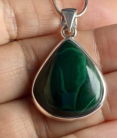 An elegant and high quality (AAA) Malachite and silver pendant including the chain. This stone is a good size and is of a beautifully refreshing green colour. Malachite is an important protection stone and this piece  is pear-cut and set in a fine detailed silver setting. This decorate setting adds complexity and flair to the piece.  This pendant measure - 2.5cm long x 2.4cm wide x 0.7cm deep (measurements do not include the bail). Pendant weight - 10 grams. Clients can select the following purc Silver Emerald Teardrop Necklace, Green Teardrop Polished Jewelry, Green Spiritual Jewelry With Polished Finish, Green Polished Sterling Silver Gemstones, Green Sterling Silver Teardrop Pendant Jewelry, Green Polished Pendant Necklace, Green Sterling Silver Pendant Necklace, Green Pendant Necklace With Polished Finish, Green Pendant Necklace In Sterling Silver