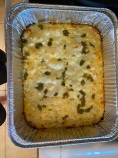 a casserole dish with broccoli and cheese in it sitting on a counter