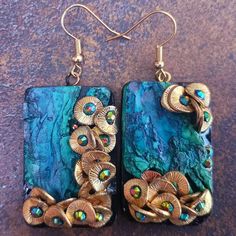 Discover these unique handcrafted earrings created from polymer clay and mixed media. Their distressed, organic design creates a luxurious statement piece, perfect for showcasing your individual style. Enjoy complimentary gift-wrapping for an added touch of elegance. Elevate your accessory game today! Unique Polymer Clay Earrings For Gift, Gift Polymer Clay Earrings, Unique Polymer Clay Earrings For Gifts, Unique Gold Polymer Clay Jewelry, Handmade Nature-inspired Resin Earrings, Gold Polymer Clay Jewelry For Crafting, Artisan Hand-painted Clay Jewelry, Hand Painted Polymer Clay Earrings For Gift, Artsy Clay Earrings For Gift