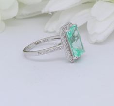 "Make a purchase of $50 or more and receive 10% Off Use Coupon Code \"JOON10OFF\" Ring Specifications: Metal: Sterling Silver Metal Purity: 92.5% Ring Height: 16mm Band Width: 3mm Gemstone: Simulated Diamond, Simulated Paraiba Spinel Gemstone Shape: Round Gemstone Color: Colorless, Paraiba Approximate Total Carat Weight: 6.50 Gemstone Clarity: Flawless Gemstone Creation Method: Simulated Plating: N/A 100% Nickel Free/Lead Free Gift Box Included Don't know your ring size? Here you can find a link Bridal Art, Spinel Gemstone, Ring Halo, Paraiba Tourmaline, Silver Prices, Halo Rings, Baguette Diamond, Cocktail Ring, Cocktail Rings