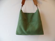 Linen and cotton sturdy canvas everyday casual slouchy hobo purse, medium bucket bag in fresh green. Exterior - High quality natural linen and cotton fabric in fresh green color - Two outside exterior slip pockets *Interior - Natural cotton in grey color. - Two inside interior pockets * Magnetic snap button closure * Real leather strap from high quality italian genuine leather in gorgeous cognac brown color. Reinforced with antique toned brass rivets. Detachable. Available in: - Cognac brown - D Everyday Cotton Bucket Bag With Removable Pouch, Canvas Hobo Bag With Pockets For Errands, Everyday Bucket Shape Hobo Bag, Cotton Shoulder Bag With Pockets For Errands, Green Large Capacity Canvas Bucket Bag, Cotton Bucket Bag With Canvas Lining, Cotton Bucket Bag With Leather Handles For Everyday Use, Bucket Hobo Bag With Rolled Handles For Travel, Versatile Everyday Hobo Bag With Rolled Handles