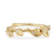 a gold ring with leaves and diamonds