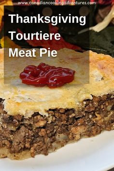 a piece of meat pie on a plate with the words thanksgiving tourtiere meat pie