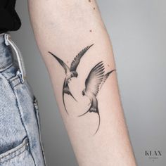 a couple of birds flying next to each other on their arm tattoo designs for men and women