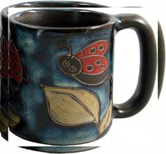 a coffee mug with ladybugs painted on it