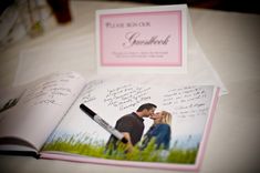 an open photo book with writing on it and a couple kissing in the middle, sitting next to each other