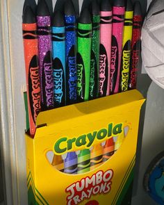 crayons are lined up in a box on the door sill for display