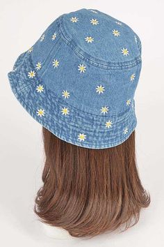 a woman's head wearing a denim hat with daisies on the front and sides