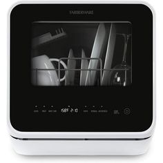 a black and white photo of an appliance with dishes in the dishwasher