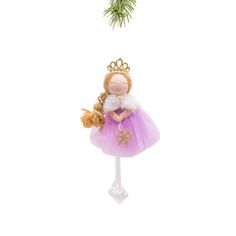 a small doll in a pink dress and crown hanging from a christmas tree ornament