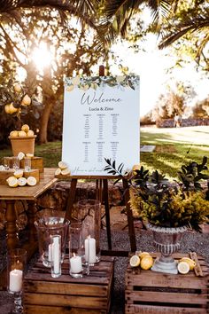 an outdoor seating area is set up for a wedding reception with candles and lemons