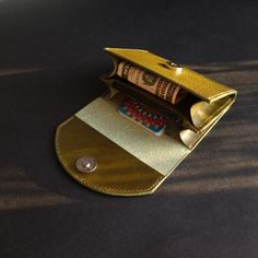 A compact, sturdy, smooth surface leather wallet for a minimalist who prefers having the mostly used cards yet with some room for coins and bills. Made of Buttero Dollaro leather, this olive green wallet will offer a nice to the touch feel and a pinch of elegance. Gold Bifold Coin Purse For Everyday Use, Green Leather Coin Purse With Rfid Blocking, Green Rectangular Coin Purse With Coin Pocket, Gold Leather Bags With Card Slots, Gold Wallet With Coin Pocket For Everyday Use, Gold Trifold Wallet With Card Slots For Everyday Use, Rectangular Green Coin Purse, Gold Leather Wallet With Card Slots, Green Trifold Wallet With Rfid Blocking As Gift