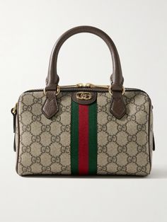 Gucci's 'Ophidia' collection stays true to the house's archival signatures. Made from monogrammed coated-canvas, this tote is overlaid with striped webbing and accented with gold-tone 'GG' hardware. Stow your phone, keys, cardholder and sunglasses inside. Porter Bag, Gucci Ophidia, Flat Dress Shoes, Chic Shoes, Raffia Bag, Gucci Fashion, Gucci Handbags, Gucci Bags, Ski Wear