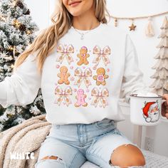 Celebrate the magic of the holiday season with our adorable Gingerbread Men & Coquette Bow Christmas Crewneck Sweatshirt! 🎄🍪 With its playful gingerbread men and delicate coquette bows, this sweatshirt captures the sweetness of Christmas while keeping you warm and stylish. 🌟 Key Features: -Soft & Cozy Fabric: Made from a high-quality blend of cotton and polyester, this crewneck sweatshirt is soft against the skin and designed for all-day comfort, perfect for those chilly winter days. -Festive Design: The delightful gingerbread men and coquette bows create a warm holiday vibe that's sure to spread cheer wherever you go. -Versatile Style: Great for holiday gatherings, cozy nights by the fire, or everyday wear. Pair it with jeans, leggings, or skirts for a cute and festive look. -Flatterin Men Coquette, Christmas Crewneck Sweatshirt, Coquette Bows, Bow Christmas, Christmas Crewneck, Gingerbread Men, Sweatshirt Cute, Coquette Bow, Cozy Fashion