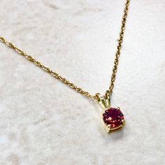 Beautiful 14 karat yellow gold pendant necklace featuring a natural 5 mm round garnet, the birthstone for January. The gemstone weighs approximately 0.60 carat. Weighs 0.89 gram. Birthstone: January. Condition: Brand New. - 14 day return policy, no questions asked. - Free insured shipping in the US. - International shipping available. Visit our website for more details about our company: www.weiljewelry.com Gold Round Cut Birthstone Necklace In Fine Jewelry Style, Gold Round Cut Birthstone Necklace Fine Jewelry, Gold Round Cut Birthstone Necklace, Formal Gold Necklace With Round Stone, Gemstone Necklace With Round Pendant For Celebration, Gold Round Stone Birthstone Necklace, Gold Fine Jewelry Birthstone Necklace, Gold Birthstone Necklace Fine Jewelry, Gold Solitaire Necklace With Round Stone For Anniversary