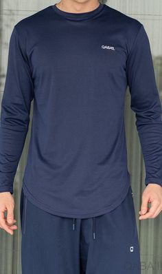 QL Lightweight Long Sleeves T-shirt 60T in Indigo Description: Do yourself a favor and make QL Lightweight Long Sleeves T-shirt 60T your go-to shirt for an easy and stylish look this summer! Built with functionality, versatility and comfortability in mind and made from materials that provide comfort on hot days. They're perfect not only for the gym but also for running errands, going on a picnic, or just walking on the beach. These shirts will keep you cool, fashionable and comfy all summer long Modern Islamic Clothing, Indigo Clothing, Walking On The Beach, Relaxed Trousers, T Shirt World, Urban Lifestyle, Islamic Clothing, Cargo Joggers, Vintage Pants