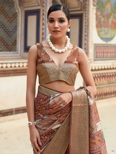 Elevate your ethnic wear collection with our incredible brown digital printed silk events wear saree with blouse. This stunning saree comes in hues of brown, made from luxurious silk material with digital print work and intricate zari weaving. The printed work elevates its charm, making it the perfect pick for any special occasion or festival.
The saree comes with an unstitched blouse material in a similar brown silk material with printed work to complement the overall look. With a length of 5.5 Brown Banarasi Silk Saree With Zari Work, Brown Blouse Piece With Zari Work In Traditional Drape, Traditional Drape Blouse Piece With Pallu In Brown, Brown Tussar Silk Saree With Pallu Detail, Brown Silk Saree With Zari Work, Brown Blouse Piece With Pallu For Diwali, Diwali Brown Blouse Piece With Pallu, Brown Tussar Silk Saree With Pallu, Unstitched Brown Saree For Festivals