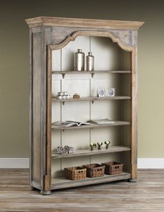 an old wooden bookcase with shelves and baskets