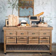 a wooden dresser sitting in front of a mirror on top of a floor next to a wall