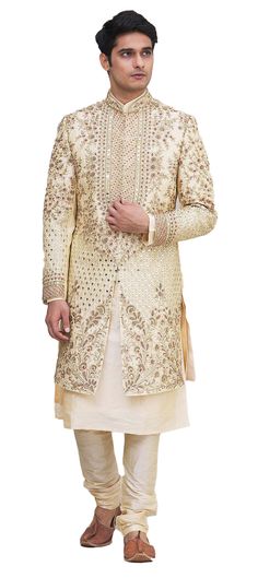 Gold Embroidered Churidar For Reception, Cream Embroidered Sherwani For Diwali, Embroidered Long Sleeve Churidar For Reception, Embroidered Cream Sherwani For Diwali, Cream Long Sleeve Embroidered Fabric For Wedding, Cream Long Sleeve Embroidered Wedding Fabric, Beige Traditional Wear With Intricate Embroidery For Eid, Eid Beige Traditional Wear With Zari Work, Semi-stitched Gold Embroidered Sherwani