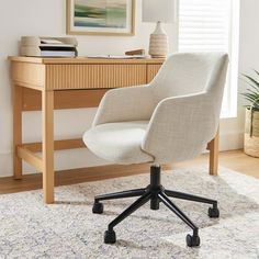 an office chair sitting on top of a rug in front of a desk with a lamp