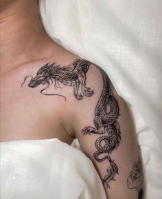 a woman with a dragon tattoo on her shoulder