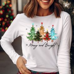 Welcome to Our Shop! Merry and Bright Christmas Tree Longsleeve Shirt,Christmas Tree shirt,Xmas Longsleeve Tshirt for Men,New Year Tee,Unisex T-shirt We offer a range of eco-friendly apparel, including Bella+Canvas unisex soft t-shirts, long sleeves, women's shirts, and V-neck shirts, Gildan sweatshirts & hoodies, Next Level tank tops for men and women, and 100% cotton baby bodysuits and long sleeve bodysuits from Gerber, Rabbit Skins, and LAT. Choose the perfect size, color, and design for you! Winter Holiday Long Sleeve T-shirt, Holiday Long Sleeve Top With Graphic Print, Long Sleeve Graphic Print Top For Holiday, Graphic Print Long Sleeve Tops For Holiday, Christmas Long Sleeve Cotton Tops, Long Sleeve Cotton Christmas Top, Casual Long Sleeve Christmas T-shirt, Long Sleeve T-shirt For Winter Holiday, Winter Graphic Long Sleeve T-shirt