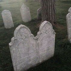 an old cemetery with headstones in the grass