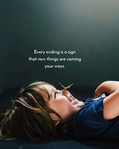 a little boy laying on top of a bed next to a sign that says, every ending is a sign that new things are coming in your ways