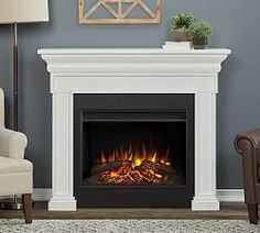 a living room with a fire place and chair in front of the fireplace that is lit