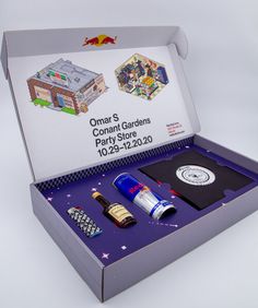 an open box with various items in it on a white surface, including bottles and magnets