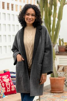 Luis Enrique Gonzales creates this soft and very warm kimono-style coat of cozy baby alpaca and wool. Reversible for versatility, its classic lines are complemented with a sophisticated color combination of charcoal grey with black trim, and lighter grey trimmed in black. Easy fit dropped shoulders, long wide sleeves and front pockets take this design everywhere all winter long. Peru Alpaca, Alpaca Poncho, Alpaca Coat, Reversible Coat, Baby Alpaca, Accessories Jacket, Wide Sleeves, Kimono Fashion, Black Trim