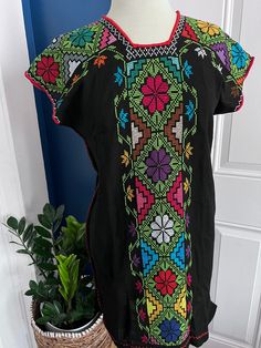 Huenango dress embroidered by hand in cross stitch and waist loom by Artesanas de Michoacán México.🌺 Hand embroidered Dress by Artisans from Michoacán Mexico. Size: Small 📏Measures: 51cm bust 81 cm long (I recommend taking your measurements to be sure of your purchase) 🧺 Care: Hand wash with liquid detergent and hang to dry. **end comes out Bohemian Dress With Multicolor Embroidery And Woven Motifs, Bohemian Embroidered Dress With Woven Motifs, Multicolor Embroidered Dress For Cinco De Mayo, Folk Style Dress With Geometric Embroidery, Multicolor Floral Embroidered Dress For Traditional Ceremonies, Multicolor Embroidered Dress For Cinco De Mayo Fiesta, Traditional Cotton Embroidered Dress For Cinco De Mayo, Traditional Embroidered Cotton Dress For Cinco De Mayo, Folk Multicolor Embroidered Dress For Fiesta